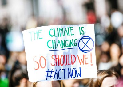 a sign that says 'the climate is changing, so should we! #actnow'